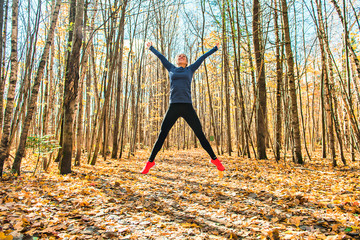A Bautiful running woman jogging in autumn nature