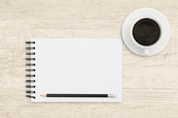 Fototapeta na wymiar Top view business background of white paper sheet of notebook with coffee cup on wood background.