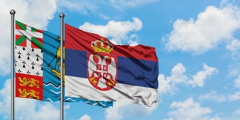 Saint Pierre And Miquelon and Serbia flag waving in the wind against white cloudy blue sky together. Diplomacy concept, international relations.