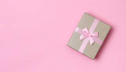 Christmas New Year Birthday template. Beautiful gift box on pastel pink paper background.