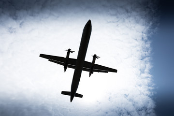 Propeller airplane flying in the cloudy skies