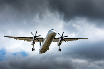 Propeller airplane flying in the cloudy skies