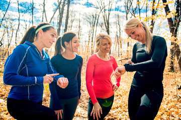 woman group out running together in an autumn park they run a race or train in a healthy outdoors...