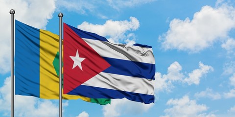 Saint Vincent And The Grenadines and Cuba flag waving in the wind against white cloudy blue sky...