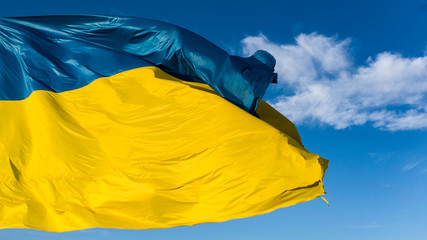 Fototapeta na wymiar Ukrainian flag background of blue sky with white clouds.