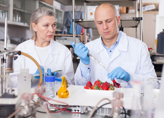 Biochemists recording experimental procedure and results