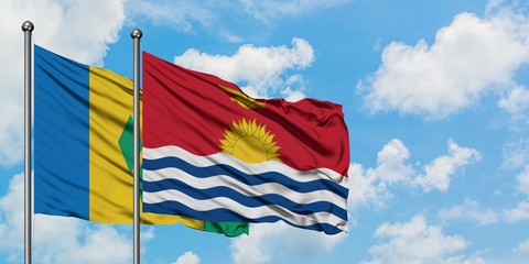 Saint Vincent And The Grenadines and Kiribati flag waving in the wind against white cloudy blue sky together. Diplomacy concept, international relations.
