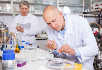 Biochemist analyzing chemical agents