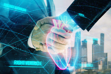 Double exposure of heart drawing on city view background with handshake. Concept of medical education