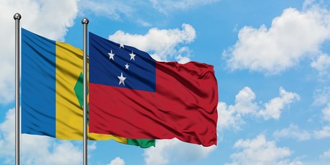Saint Vincent And The Grenadines and Samoa flag waving in the wind against white cloudy blue sky...