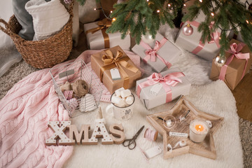 Fototapeta na wymiar Christmas decor. Christmas mood. Christmas tree, gifts, wrapping, ribbons, candle. Cozy. Holidays.