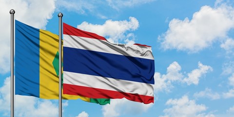 Saint Vincent And The Grenadines and Thailand flag waving in the wind against white cloudy blue sky...