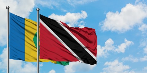 Saint Vincent And The Grenadines and Trinidad And Tobago flag waving in the wind against white...