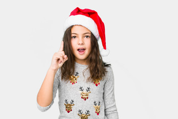 Little girl celebrating christmas day having an idea, inspiration concept.