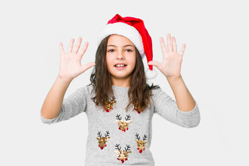 Little girl celebrating christmas day showing number ten with hands.