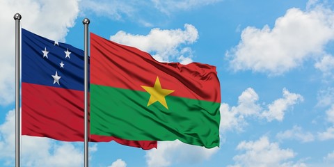 Samoa and Burkina Faso flag waving in the wind against white cloudy blue sky together. Diplomacy concept, international relations.