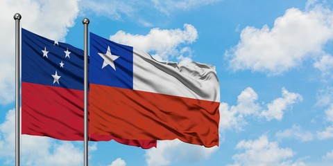 Samoa and Chile flag waving in the wind against white cloudy blue sky together. Diplomacy concept, international relations.
