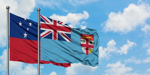 Samoa and Fiji flag waving in the wind against white cloudy blue sky together. Diplomacy concept,...