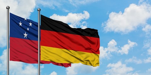 Samoa and Germany flag waving in the wind against white cloudy blue sky together. Diplomacy...