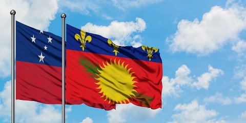 Samoa and Guadeloupe flag waving in the wind against white cloudy blue sky together. Diplomacy concept, international relations.
