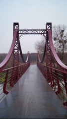  large iron wet bridge in the rain in autumn