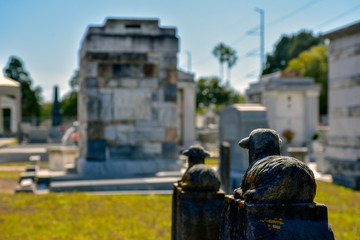 A statue of a lamb in a southern United States cemetery symbolizes the loss of a child.