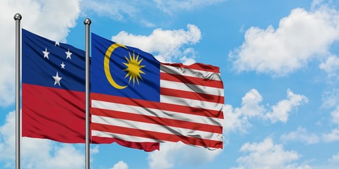 Samoa and Malaysia flag waving in the wind against white cloudy blue sky together. Diplomacy concept, international relations.