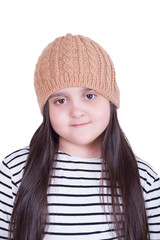 Portrait of a girl with long hair in a knitted hat