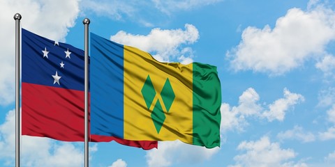 Samoa and Saint Vincent And The Grenadines flag waving in the wind against white cloudy blue sky...