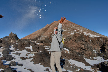 girl having fun playing with snow on the mountain