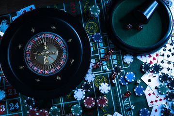 Casino background, poker Chips on gaming table, roulette wheel in motion,