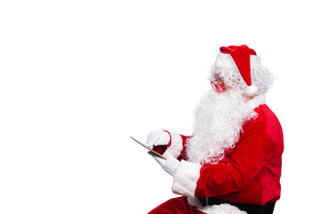 Portrait of santa clause play tablet on white background,Thailand people,Merry christmas,Modern of...