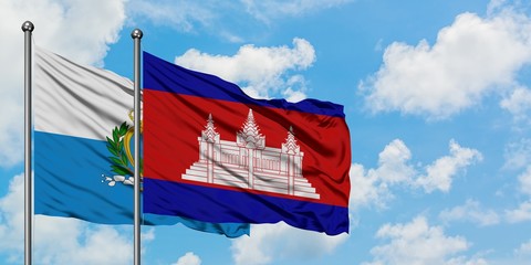 San Marino and Cambodia flag waving in the wind against white cloudy blue sky together. Diplomacy concept, international relations.
