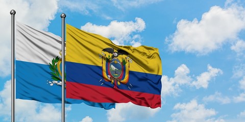 San Marino and Ecuador flag waving in the wind against white cloudy blue sky together. Diplomacy concept, international relations.