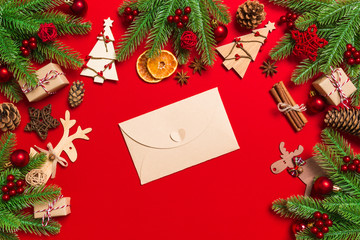 Fototapeta na wymiar Top view of envelope on red background. New Year decorations. Christmas holiday concept