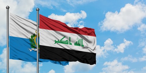 San Marino and Iraq flag waving in the wind against white cloudy blue sky together. Diplomacy concept, international relations.