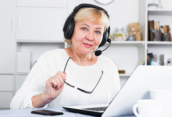 Mature woman communicates via the Internet