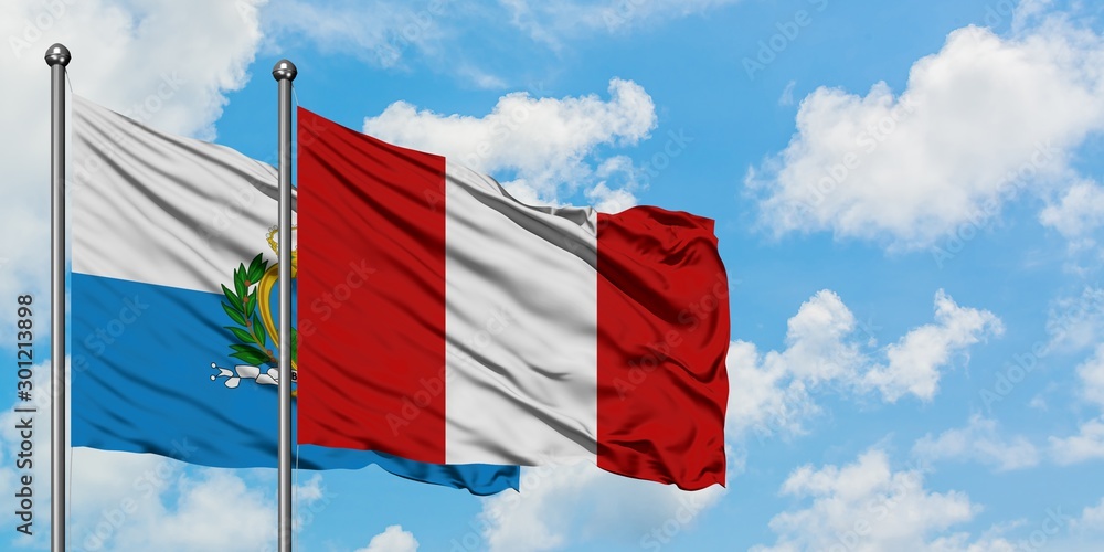 Wall mural San Marino and Peru flag waving in the wind against white cloudy blue sky together. Diplomacy concept, international relations.