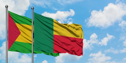 Sao Tome And Principe and Benin flag waving in the wind against white cloudy blue sky together. Diplomacy concept, international relations.