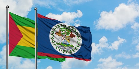 Sao Tome And Principe and Belize flag waving in the wind against white cloudy blue sky together....