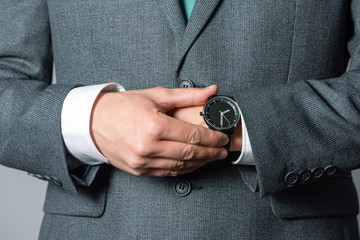 Wrist watch on businessman hand close up. Man is checking time concept.