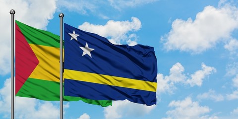 Sao Tome And Principe and Curacao flag waving in the wind against white cloudy blue sky together. Diplomacy concept, international relations.