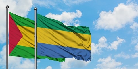 Sao Tome And Principe and Gabon flag waving in the wind against white cloudy blue sky together. Diplomacy concept, international relations.