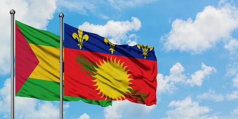 Sao Tome And Principe and Guadeloupe flag waving in the wind against white cloudy blue sky together. Diplomacy concept, international relations.