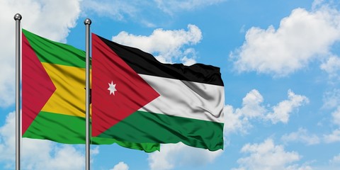 Sao Tome And Principe and Jordan flag waving in the wind against white cloudy blue sky together. Diplomacy concept, international relations.