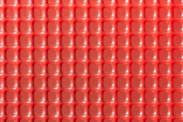 Fototapeta premium Texture with square red elements. Plastic candy lining