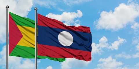 Sao Tome And Principe and Laos flag waving in the wind against white cloudy blue sky together. Diplomacy concept, international relations.