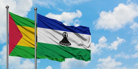 Sao Tome And Principe and Lesotho flag waving in the wind against white cloudy blue sky together. Diplomacy concept, international relations.