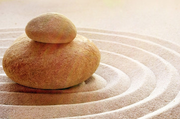 Fototapeta na wymiar zen garden meditation stone background with stones and lines in sand for relaxation balance and harmony spirituality or spa wellness