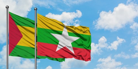 Sao Tome And Principe and Myanmar flag waving in the wind against white cloudy blue sky together. Diplomacy concept, international relations.